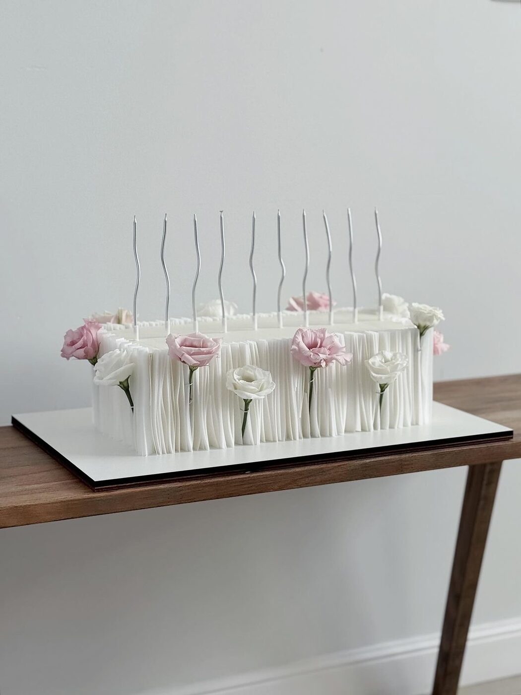 Two-tier textured wedding cake on a gold cake stand
