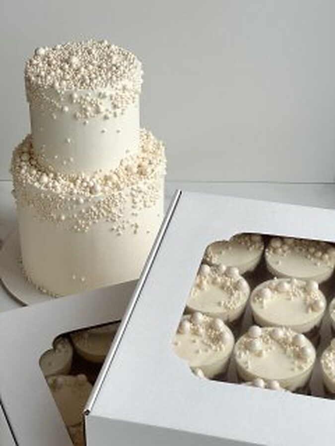 Three-tier pearl wedding cake with matching mini cakes