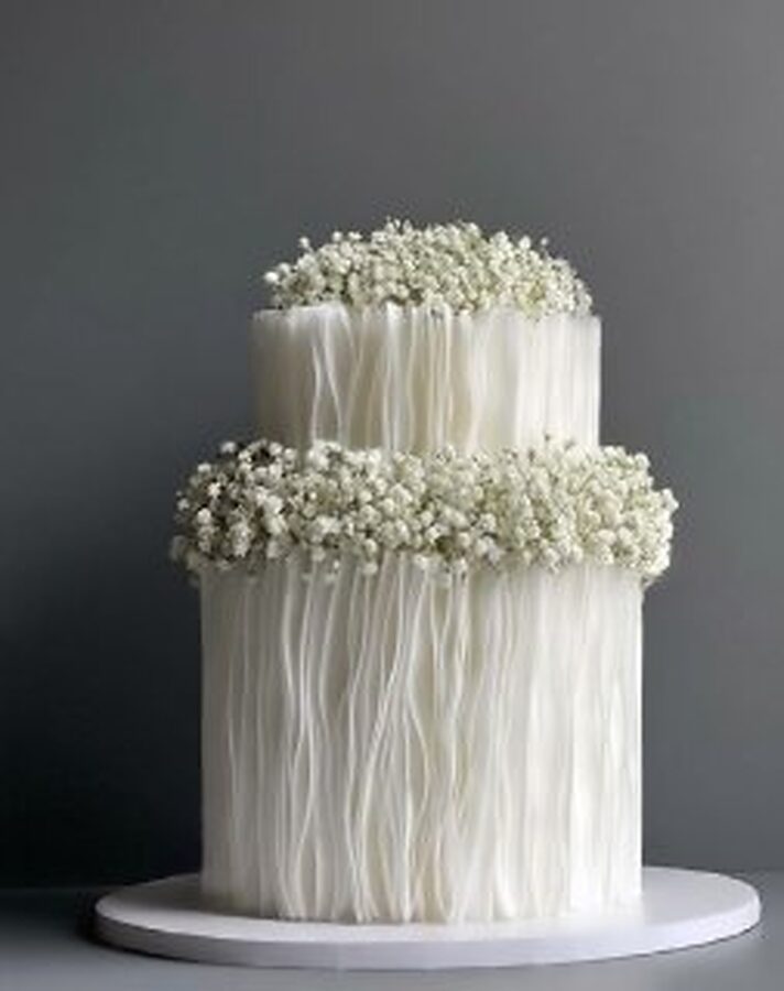 Two-tier textured wedding cake crowned with gypsophila